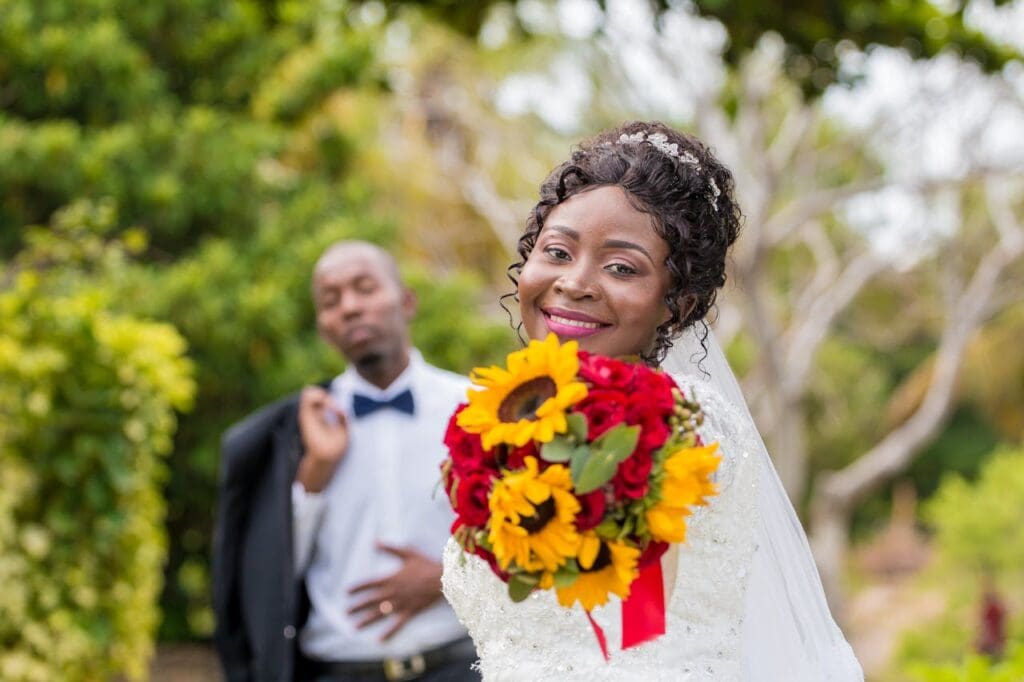 pexels photo 3657595 Joyful bride and groom celebrating their wedding with vibrant floral bouquet outdoors in Nampula.